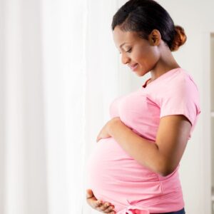 Image of a pregnant person about to schedule a prenatal massage. 