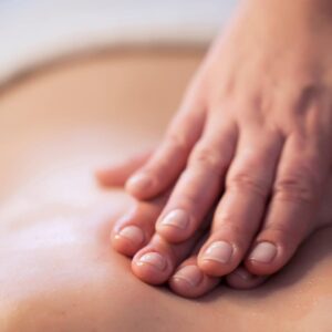 Photo of woman getting a back massage because massage can help with stress relief and pain relief. 