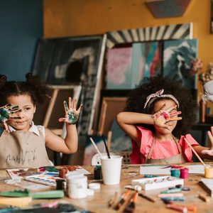 children engaged in messy painting activity representing sensory overload in kids who can’t turn off